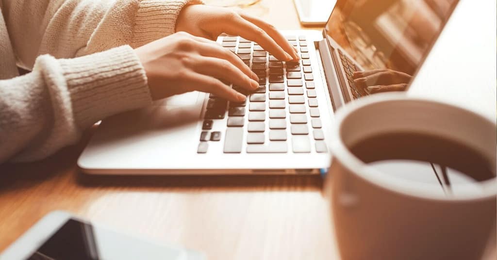 coffee beside laptop of Pinoy remote worker