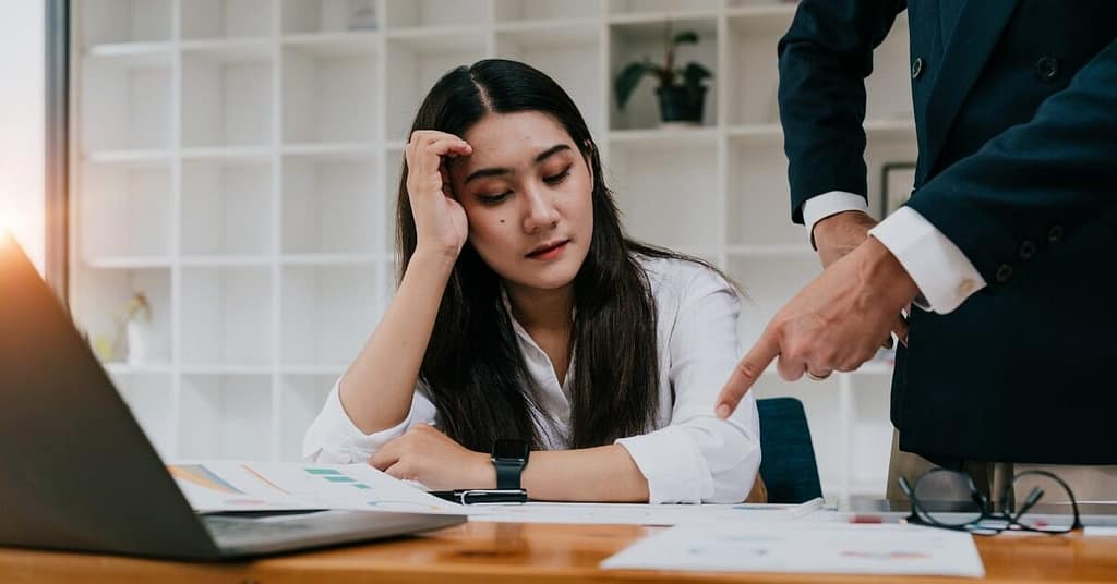Frustrated worker constantly being checked on by boss, feeling micromanaged
