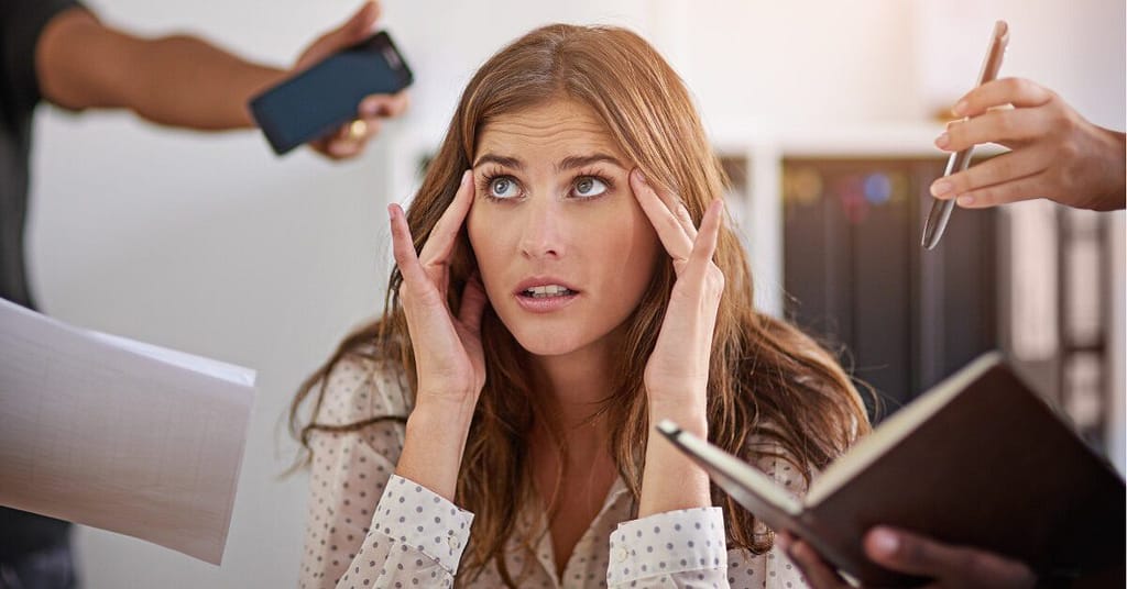 Confused employee hearing office gossip instead of real updates in toxic workplace